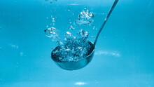 Kitchen Ladle In Water