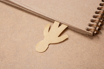 Poster - photo of a paper craft of a person as a marker for a notebook