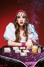 Female Fortune Teller Pointing To Tarot Cards