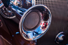 Closeup Of An Old Car Horn With A Photographer Mirrored On It