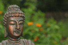 Buddha Statue With A Field Of Yellow Flowers In A Shallow  Background