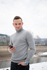 Closeup of a man in a turtleneck posing for a photo