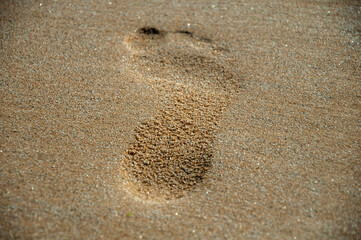 Closeup of a human footprint on the sand