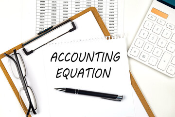 Poster - Text ACCOUNTING EQUATION on the white paper on clipboard with chart and calculator