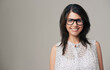 © Jeff Bergen/peopleimages.com - Spectacled beauty. Portrait of an attractive young woman smiling against a gray background.