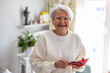 © pikselstock - Portrait of smiling senior woman at home