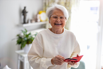 Wall Mural - Portrait of smiling senior woman at home
