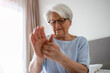 © pikselstock - Senior woman with arthritis rubbing hands