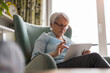 © pikselstock - Senior woman using a digital tablet at home