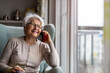 © pikselstock - Portrait of senior woman using smartphone at home