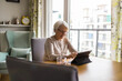 © pikselstock - Senior woman using a digital tablet at home