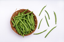 Fine Green Beans In A Wicker Bread Basket On White Background. View From Above