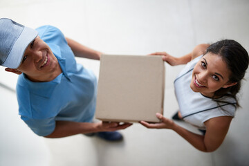 Aufkleber - Providing a service that never disappoints. Portrait of a courier making a delivery to a businesswoman at her office.