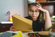 © Miljan Živković - One woman young female holding mail letter having problem with bad college entry test results refused failed - student hold her head hard lesson education and learning concept copy space