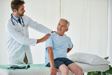 Aufkleber - The pain is worse on that side. Cropped shot of a young male doctor examining a senior patient with back pain in his office.