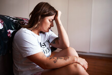 I Just Feel So Terrible. Shot Of A Woman Looking Upset While Sitting In Her Bedroom.