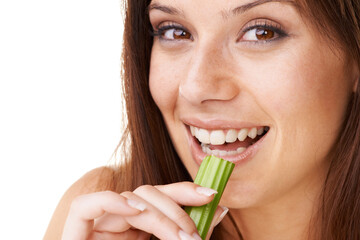 Canvas Print - Eating healthy. Portrait of a beautiful young woman eating a stick of celery.