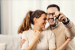 © dusanpetkovic1 - Close up of a man holding keys of new apartment for him and his wife.