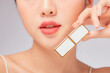 © Tuan  Nguyen  - Front view of model showing lipstick  with lip in white background for cosmetic advertising