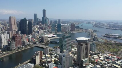 Wall Mural - Aerial skyline of Kaohsiung, a vibrant seaport city in Southern Taiwan, with 85 Sky Tower among skyscrapers by the harbor & the futuristic architecture of Music Center by the Love River under blue sky