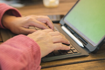 Poster - asian woman typing on keyboard with tablet online at coffee shop