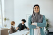 © Drazen - Portrait of confident Muslim businesswoman with crossed arms at corporate office.