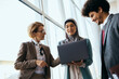 © Drazen - Young Muslim businesswoman and her colleagues cooperating while working on laptop.