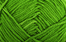 Green Knitting Wool Close-up.Green Yarn Clew Close Up Texture. Blue Wool Background.