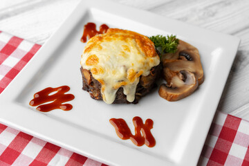 Wall Mural - Delicious veal cutlet with melted mozzarella cheese on white plate