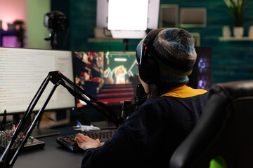 Wall Mural - Gamer doing online live stream with video games. Woman using gameplay on computer, streaming and looking at monitor with chat. Person broadcasting and playing games with microphone.