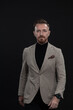 © .shock - Confident businessman walking forward wearing a causal suit, handsome senior business man hero shot portrait isolated on black