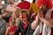 © Halfpoint - Excited football fans supproting English national team in live soccer match at stadium.