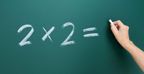 Wall Mural - Hand writing math simple equation on blackboard