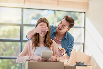 Wall Mural - The big surprise. Cropped shot of a young man surprising his girlfriend by proposing while moving house.