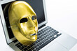 Golden mask on laptop against white background