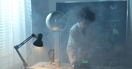 Wall Mural - physics science lab: handsome young scientist in white coat and glasses doing electrical tests. chil