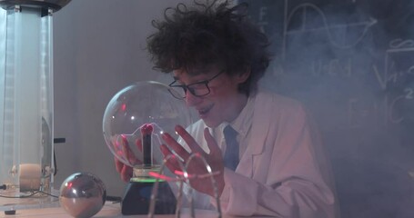 Wall Mural - education, science and kids concept - boy wearing goggles for physics lab doing electrical tests. ch