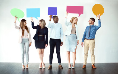 Poster - Sorry what did you say. Shot of a group of work colleagues standing next to each other while holding speech bubbles against a white background.