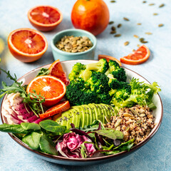 Canvas Print - Healthy vegetarian dish with vegetables, avocado, blood orange, broccoli, watermelon radish, spinach, quinoa, pumpkin seeds. Buddha bowl. Balanced food. Delicious detox diet. Top view