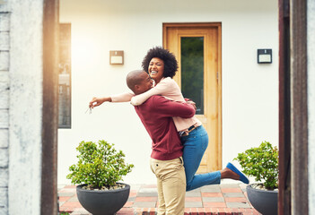 Fototapete - Finally a home of our own. Shot of a young couple celebrating the move into their new house.