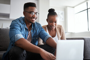 Aufkleber - Look at this brand new budget plan I created. Shot of a young couple using a laptop together at home.
