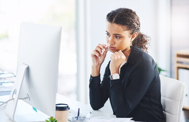 Poster - Maybe desk jobs are not meant for me. Shot of a young businesswoman looking bored while working on a computer in an office.