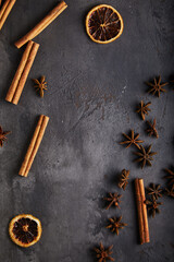 Wall Mural - spices, cinnamon, dried orange, anise on a black, old textured background. space for text.
