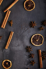 Wall Mural - spices, cinnamon, dried orange, anise on a black, old textured background. space for text.