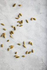 Wall Mural - spices, cardamom grains on a gray concrete background. space for text.