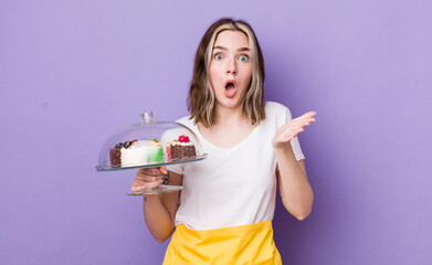 pretty caucasian woman feeling extremely shocked and surprised. home made cakes concept