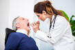 © Minerva Studio - Doctor examining a patient in her office