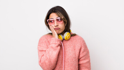 Wall Mural - pretty hispanic woman feeling bored, frustrated and sleepy after a tiresome. headphones concept