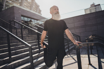 Photo of old grey hair fit man do sport wear black t-shirt shorts outside in town