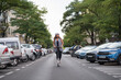 © ADDICTIVE STOCK - Smiling black woman riding electric scooter on asphalt road